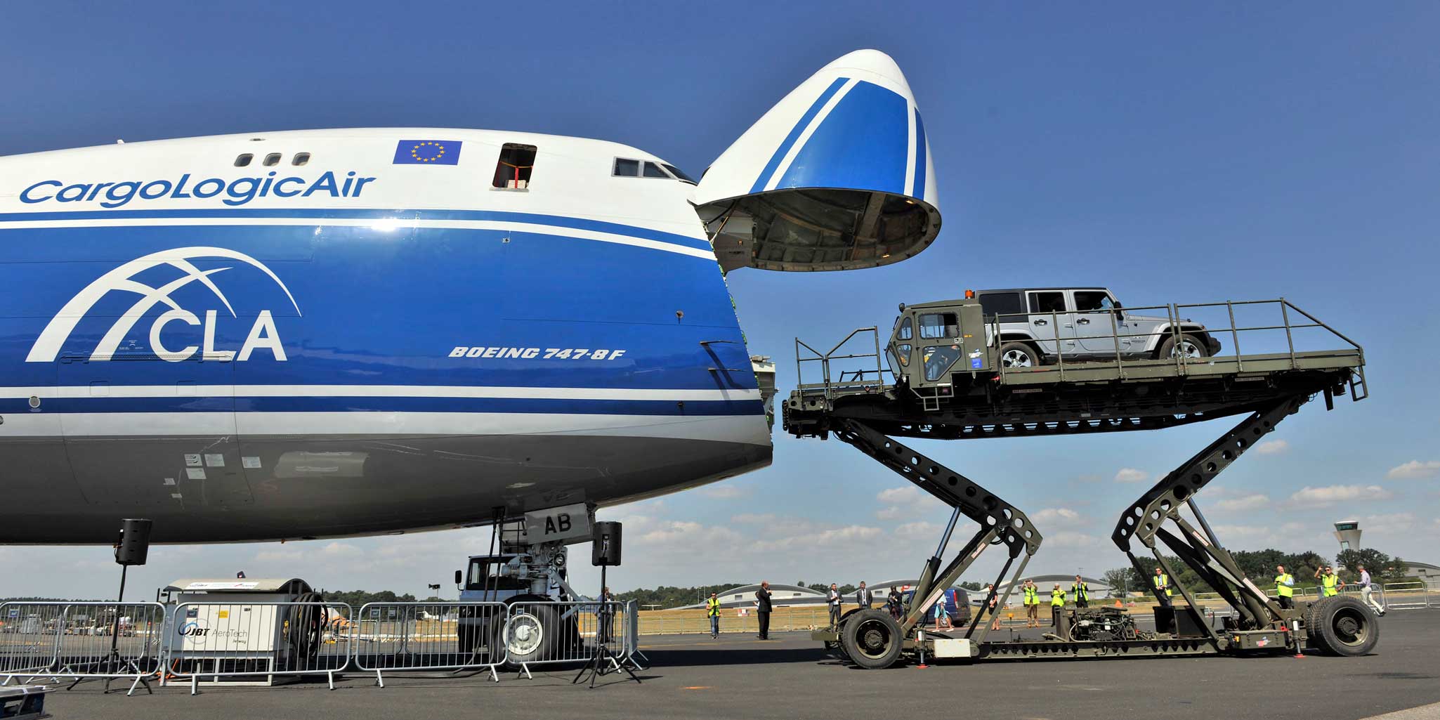 CargoLogicAir Boeing 747-8F - Boeing 747-83QF cargo airliner loading a small truck on a scissor-jack lift in the static-display at the Farnborough Airshow 2018